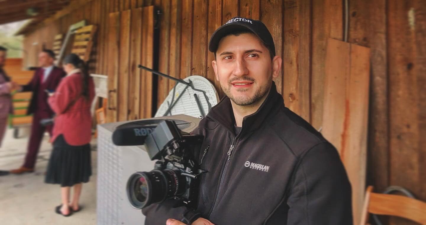 Joseph of Mountain of Stone Media, Louisiana wedding videographer, holding a professional cinema camera